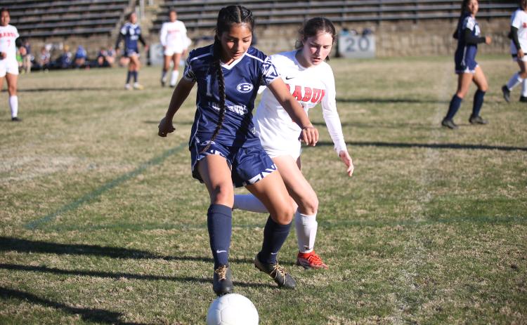 Vivian Salazar covers the ball from a Rabun County defender during the Lady Devils’ region matchup March 14.