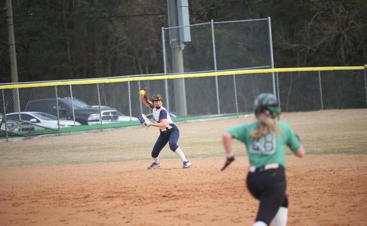Ava Lunsford throws in a ball during the Lady Devils’ slow pitch softball game against Franklin County High School March 16. (Photo by Wells)