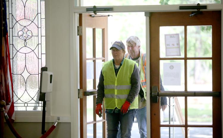 Pictured is Elrod being greeted and surprised by the crowd as she walks in the Bowman Community Center with public works employee Lloyd Ivester. (Photo by Wells)