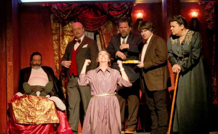 Tracy Bennett (front) as “Greta Ohlsson” drops to her knees in agony after a murder is discovered as part of the Elbert Theatre’s upcoming production of Agatha Christie’s “Murder on the Orient Express.” Also pictured are (back row, L-R) Robert Roach as “Samuel Ratchett,” Michael Weis as “Hercule Poirot,” Philip Hiott as “Monsieur Bouc,” Jake Triplett as “Hector MacQueen” and Jennifer White as “Princess Dragomiroff.” (Photo by Wells)