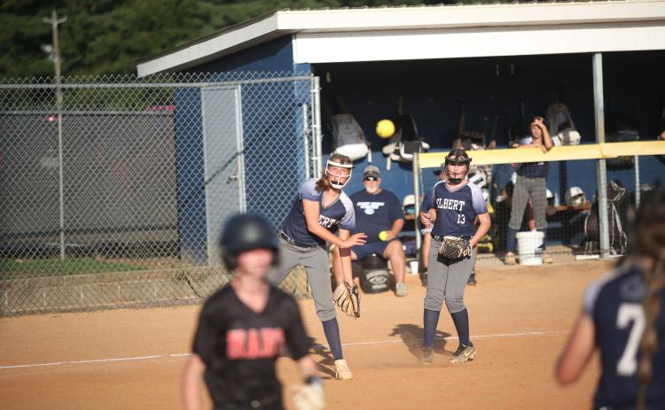 Haley Jones (right) looks on as Ella Harris (left) tries to throw a Hart County runner out at first base Aug. 17. Elbert went on to lose 15-6 to Hart, but got back into the win column with an 11-1 win over Washington-Wilkes Aug. 19. (Photo by Wells)