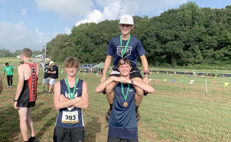 Ezra Adamson, (top) Dakota Toole and (bottom) Connor Holland pose with their Top 10 medals after the meet in Franklin County Sept. 9. (Photo by Wells) 
