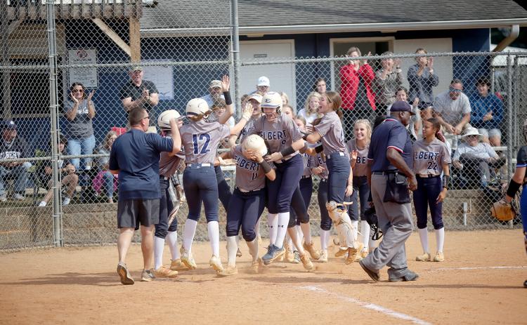 The Lady Devils swarm Ky Dubose at the plate after she hit a home run in Elbert’s game against Trion Oct. 19.  (Photo by Wells)