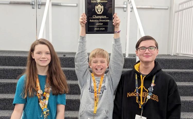 Pictured are (L-R) the Book Battle team members, who also participated in the Robotics Showcase, Chloe David, Levi Wiles and Adrian Jenkins.
