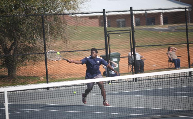 Jasean Jenkins charges the net during his win in the boys No. 1 doubles match against Hart. (Photo by Wells)
