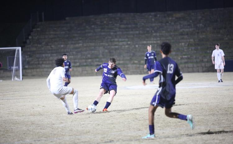 Jace Terrell kicks the ball past an opponent. (File photo by Wells)