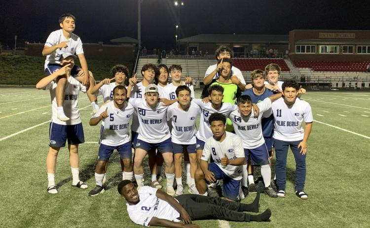 The Devils Soccer team celebrates after beating Social Circle 5-2 on the road in the first round of the GHSA State Playoffs. The win marked the second-ever playoff win in the soccer  team’s history. (Photo courtesy of Elbert County True Blue)