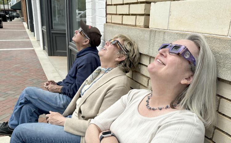 Members of The Elberton Star staff (right, L-R) Earl Saxon, Valerie Evans and Barbara Slay enjoyed viewing the eclipse (left) with safety glasses. (Photo by Scoggins) 